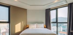 Letto o letti in una camera di Maxx Jeju, a member of H Rewards