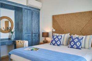 Un dormitorio con una cama grande con cabecero azul. en Luxury Protaras Villa Villa Najenda 3 Bedrooms Private Outdoor Pool Furnished Sun Terrace Shaded Furnished Terrace Private Garden Fig, en Protaras