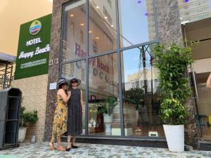 two women are standing in front of a store at Happy Beach Hotel in Nha Trang