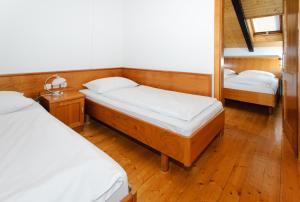 a bedroom with two beds and a mirror at Bungalows Rogla in Zreče