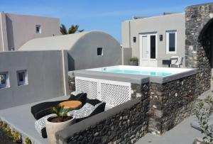 a balcony with a swimming pool on a house at Luxury Santorini Villa Villa Elysian Tessera Private Pool 1 Bedroom in Foinikiá