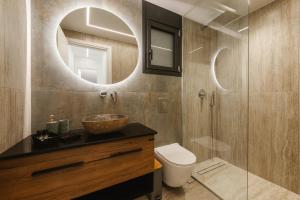a bathroom with a sink and a toilet and a mirror at Zandore Villas Perdika private Luxury Villas Epirus Villas in Pérdika