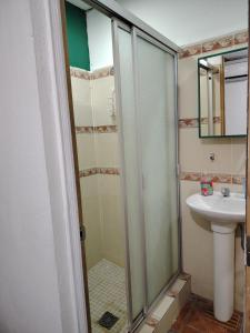 a bathroom with a shower and a sink at Pacific Room El Tunco Surf City in Tamanique