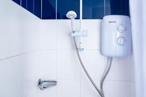 a shower in a white tiled bathroom with a faucet at Albert Court in Liverpool in Liverpool +29 photos