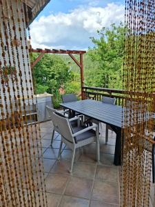 a wooden table and chairs on a patio at Krez Ferienhaus in Plein