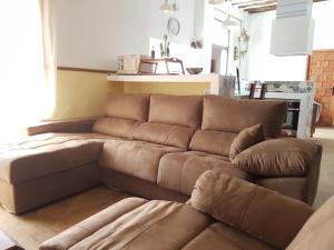 a brown leather couch in a living room at Cortijo de los Castellanos in Las Ventanas