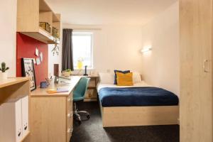 a bedroom with a bed and a desk and a sink at Albert Court in Liverpool in Liverpool
