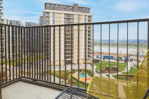 a balcony with a chair and a view of a building at Central Belgrade Apartments BW in Belgrade