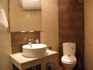 a bathroom with a sink and a toilet at Anteya Serdika Apartments in Sozopol +29 photos