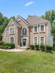 a large brick house with a landscaping at Pprevalon in Gastonia