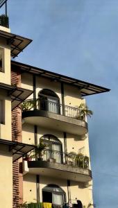 a tall building with balconies and plants on it at Chakk 109 Mussoorie Foothills, Dehradun in Dehradun