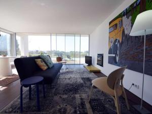 a living room with a couch and a tv at Contemporary Caminha Villa 2 Bedrooms Villa Oceanic Escape Private Pool & Uninterrupted Sea Views North Portugal in Caminha