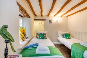 a bedroom with two beds and a parrot on the wall at 4 Bed in Cartmel oc-d31802 in Cartmel