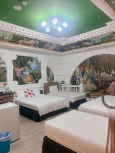 a bedroom with two beds and a painting on the ceiling at Good 9 Stay Inn in Taipei