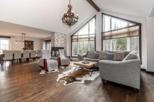 a living room with a couch and a table at Chalet in the Woods, Serenity in Saint Come