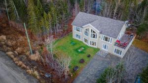 an overhead view of a white house in the woods at Chalet in the Woods, Serenity in Saint Come