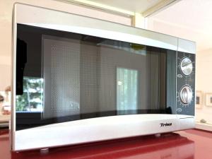 a microwave oven sitting on top of a red table at Fortuna 220 in Leukerbad