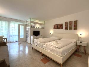 a bedroom with a large white bed in a room at Fortuna 220 in Leukerbad