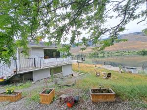 a house with three flower boxes in the yard at Private Bedroom at Riverfront House in Kamloops +2 photos