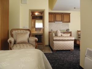 a room with a bed and a couch and a chair at Anteya Serdika Apartments in Sozopol