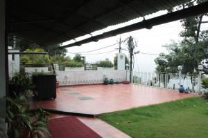 a patio with a white fence at Ivy Suites in Bhopal