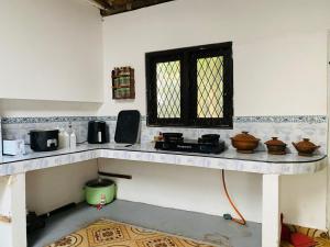 a kitchen with a counter in a room at Chill Hostel Madiha in Matara
