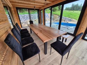 a dining room with a wooden table and chairs at SPAcówka - mini SPA w Beskidach in Jaworzynka