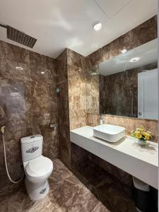 a bathroom with a toilet and a sink at Da Nang Daisy Apartment in Danang +243 photos