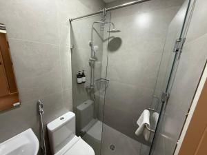 a bathroom with a toilet and a glass shower at City Centre B&B in Tashkent