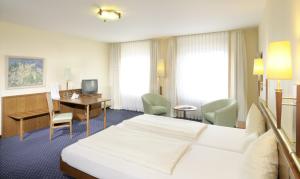 a hotel room with a bed and a desk at Victoria Hotel in Minden