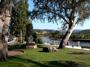 a park with a view of a river and trees at Pensión Teyma in Ponteceso