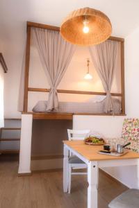 Un dormitorio con una litera con una mesa y una cama. en Exoxiko Summer House, en Myrties
