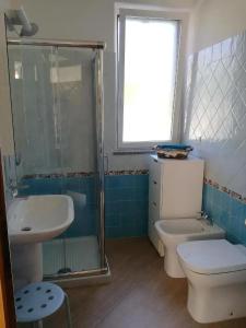 a bathroom with a toilet and a sink and a shower at Bed & Breakfast Ca' di Camineve in Loano