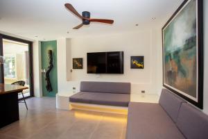a living room with a couch and a ceiling fan at Encantada Residences in Boracay