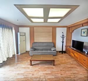 a living room with a couch and a television at Gyeongju Ilsung Condo in Gyeongju +10 photos