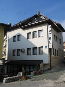 a white building with a sign that reads hotel at Hotel Stari grad in Jajce