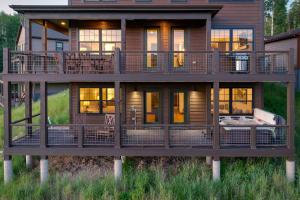 a large wooden house with a large deck at Aspen View Chalet home in Fraser