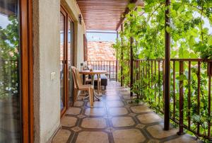 a patio with a table and chairs on a balcony at Only Flowers Girls Hostel in Tbilisi City