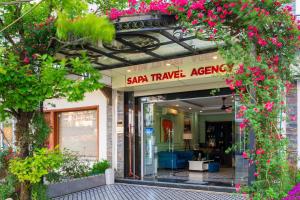 an entrance to a store with pink flowers at THE 1903 Sapa in Sapa