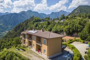 an aerial view of a house with mountains in the background at Residence Bellevue in Tremosine Sul Garda