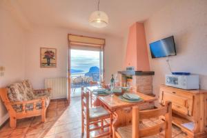 a living room with a table and a television at Residence Bellevue in Tremosine Sul Garda