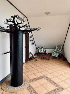 a room with a tree in the middle of a room at La Salazienne in Salazie