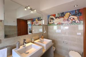 a bathroom with two sinks and a mirror at Taormina center 4 BR penthouse, terrace with views in Taormina