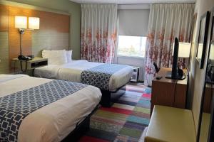 a hotel room with two beds and a television at Gallus Stadium Park Inn, an Ascend Collection Hotel in Columbia