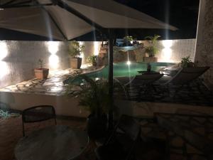 a swimming pool with a table and an umbrella at Private Villa in Grand Bay in Grand Baie +8 photos
