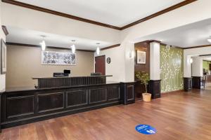 a lobby with a waiting area with a cash register at Sleep Inn & Suites Bush Intercontinental - IAH East in Humble +40 photos