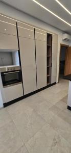 a kitchen with white cabinets and a stove at Le luxe MENZAH5 in Ariana