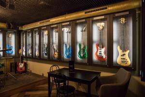 a row of guitars hanging on a wall in a room at Apart Hotel GOLDEN apartments in Košice