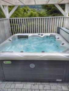 a hot tub on a deck with a fence at Miodomki in Brenna