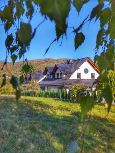a house in a field with a fence at Miodomki in Brenna